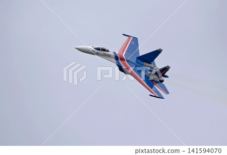 Russia Kubinka 12 April 2025. Russian Knights aerobatic team performing on Su-30SM and Su-35S fighter jets during an air show. Military aircraft in formation flight with smoke trails against blue sky Russia Kubinka 12 April 2025. Russian Knights aerobatic team performing on Su-30SM and Su-35S fighter jets during an air show. Military aircraft in formation flight with smoke trails against blue sky 141594070