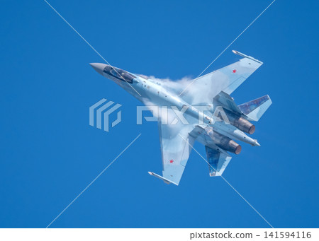 Russia Kubinka 12 April 2025. Russian Knights aerobatic team performing on Su-35 fighter jets during an air show. Military aircraft in formation flight with smoke trails against blue sky Russia Kubinka 12 April 2025. Russian Knights aerobatic team performing on Su-35 fighter jets during an air show. Military aircraft in formation flight with smoke trails against blue sky 141594116