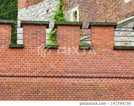 Krakow, Poland - August 6, 2023: Crenellated Wall Detail at Wawel Castle Krakow, Poland - August 6, 2023: Crenellated Wall Detail at Wawel Castle 141594236