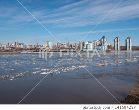 April 09 2026 Barnaul Russia aerial view of Ob River ice drift floating ice with new high-rise buildings near River Station spring cityscape urban development. April 09 2026 Barnaul Russia aerial view of Ob River ice drift floating ice with new high-rise buildings near River Station spring cityscape urban development. 141594257