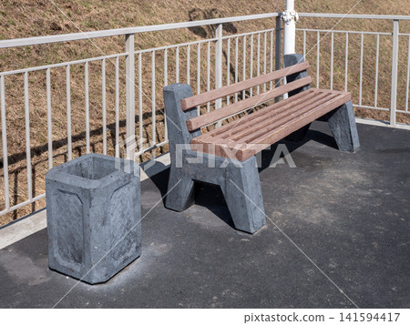Park bench with trash bin in urban park outdoor seating recreation public space. Park bench with trash bin in urban park outdoor seating recreation public space. 141594417