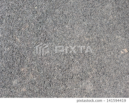 Rubber sports surface background outdoor playground flooring texture under asphalt shock absorbing material. Rubber sports surface background outdoor playground flooring texture under asphalt shock absorbing material. 141594419
