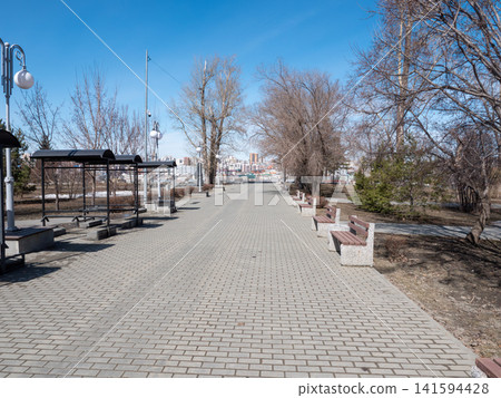 Park benches in urban park outdoor seating recreation public space green area. Park benches in urban park outdoor seating recreation public space green area. 141594428