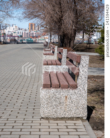 Park benches in urban park outdoor seating recreation public space green area. Park benches in urban park outdoor seating recreation public space green area. 141594429