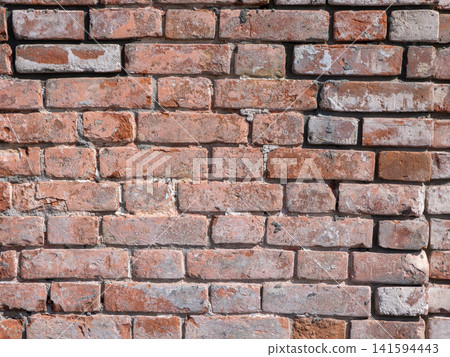 Old red brick wall texture weathered and peeling surface grunge background for design use. Old red brick wall texture weathered and peeling surface grunge background for design use. 141594443