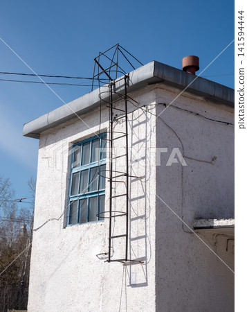 Building facade with metal staircase on wall exterior urban architecture industrial detail. Building facade with metal staircase on wall exterior urban architecture industrial detail. 141594444