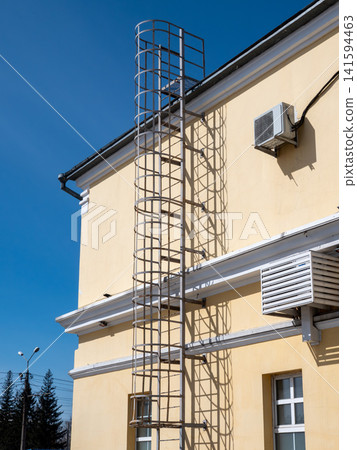 Building facade with metal staircase on wall exterior urban architecture industrial detail. Building facade with metal staircase on wall exterior urban architecture industrial detail. 141594463