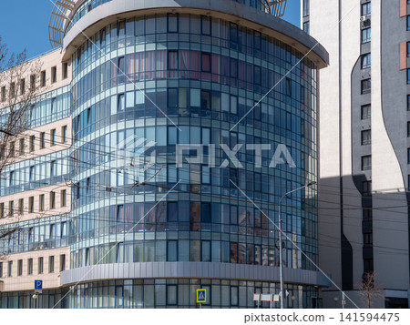 Modern glass buildings facade with reflective windows architectural background. Modern glass buildings facade with reflective windows architectural background. 141594475