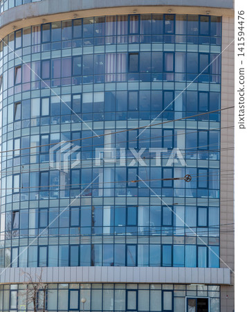 Modern glass buildings facade with reflective windows architectural background. Modern glass buildings facade with reflective windows architectural background. 141594476