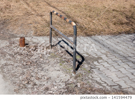 Old rusty metal fence on dry soil with grass rural outdoor landscape. Old rusty metal fence on dry soil with grass rural outdoor landscape. 141594479