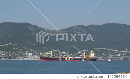 August 24, 2025: Large cargo ship entering the port of Novorossiysk, Russia, on the Black Sea, illustrating maritime transport, industrial shipping and coastal infrastructure August 24, 2025: Large cargo ship entering the port of Novorossiysk, Russia, on the Black Sea, illustrating maritime transport, industrial shipping and coastal infrastructure 141594564