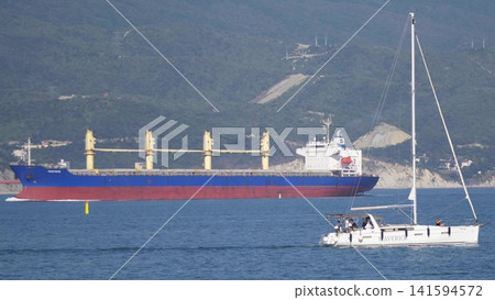 August 24, 2025: Large cargo ship entering the port of Novorossiysk, Russia, on the Black Sea, illustrating maritime transport, industrial shipping and coastal infrastructure 141594572