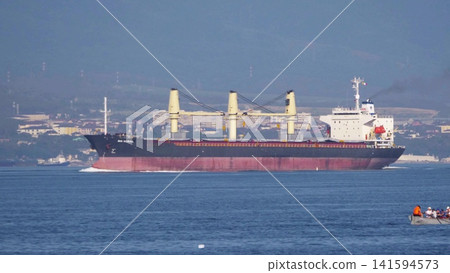 August 24, 2025: Large cargo ship entering the port of Novorossiysk, Russia, on the Black Sea, illustrating maritime transport, industrial shipping and coastal infrastructure 141594573