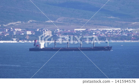 August 24, 2025: Large cargo ship entering the port of Novorossiysk, Russia, on the Black Sea, illustrating maritime transport, industrial shipping and coastal infrastructure August 24, 2025: Large cargo ship entering the port of Novorossiysk, Russia, on the Black Sea, illustrating maritime transport, industrial shipping and coastal infrastructure 141594576