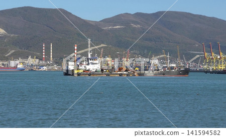 August 22 2025 View of Novorossiysk port Russia with cargo ships and cranes on the coastline. Industrial maritime scene on the Black Sea 141594582
