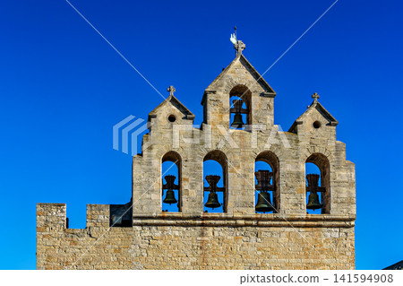 The bell tower on the church notre dame de la mer in Saintes-Maries-de-la-Mer, France. The bell tower on the church notre dame de la mer in Saintes-Maries-de-la-Mer, France. 141594908