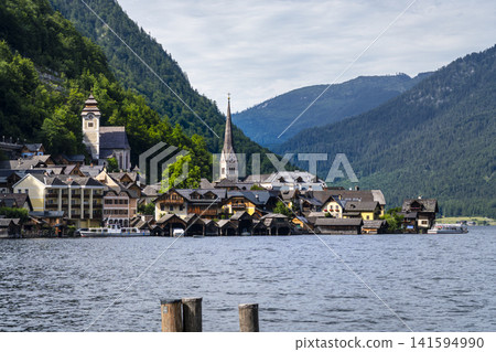 Hallstatt village with its church on the lake in Salzkammergut, Upper Austria, suitable as a calm wallpaper or background. 141594990
