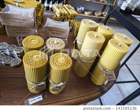 Xalo, Spain - June 20, 2026.Natural handmade rolled beeswax honeycomb candles on display at a craft store during daytime Xalo, Spain - June 20, 2026.Natural handmade rolled beeswax honeycomb candles on display at a craft store during daytime 141595236