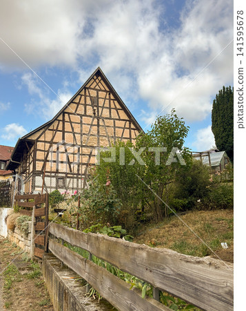 Traditional half-timbered farmhouse with rustic garden in Steinenbronn, Baden-Wuerttemberg, Germany 141595678