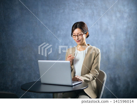 Business woman using a personal computer Business woman using a personal computer 141596014