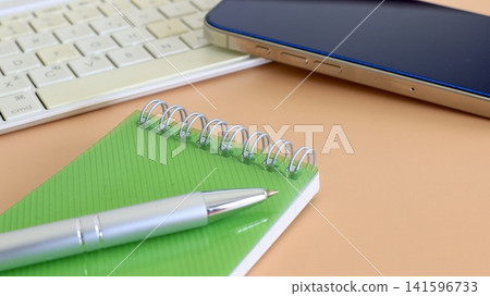 A notebook for jotting down ideas and a smartphone 141596733