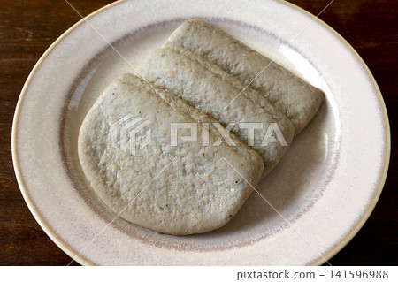 Black fish cake as a table background Black fish cake as a table background 141596988