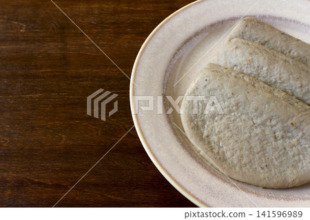 Black fish cake as a table background Black fish cake as a table background 141596989