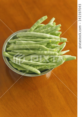 Fresh green beans in a stainless steel bowl Fresh green beans in a stainless steel bowl 141597043