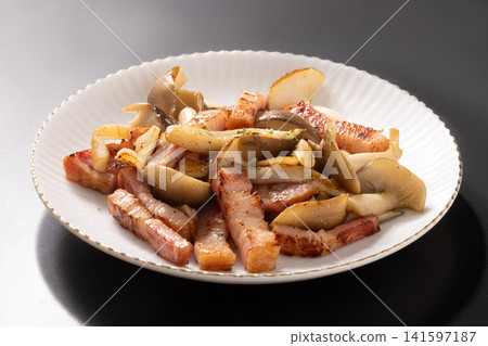 Bacon and large buna shimeji mushrooms stir-fried in butter and soy sauce. Bacon and large buna shimeji mushrooms stir-fried in butter and soy sauce. 141597187