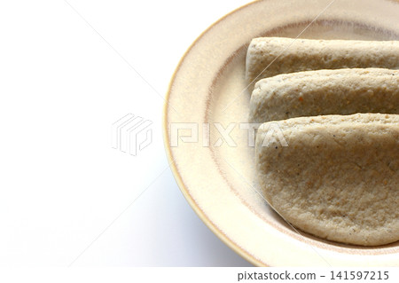 Black fish cake on a white background 141597215