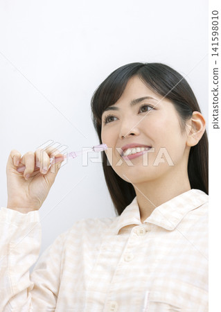 Woman in tooth brushing pajamas Woman in tooth brushing pajamas 141598010