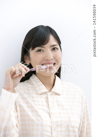 Woman in tooth brushing pajamas Woman in tooth brushing pajamas 141598034