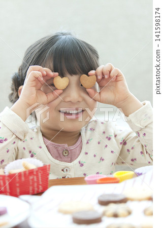 Girl making cookies Girl making cookies 141598174