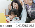 Families reading books in the living room 141598198
