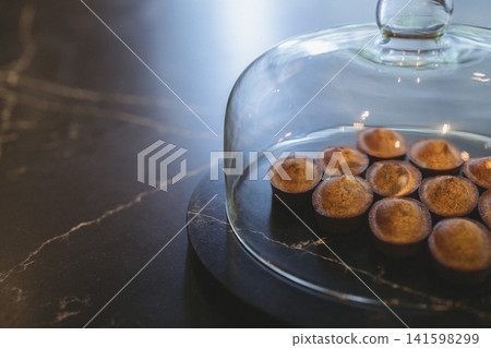 Financiers in a glass dome and a marble table Financiers in a glass dome and a marble table 141598299