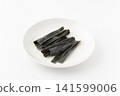 Chewing kelp on a plate against a white background. 141599006