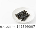 Chewing kelp on a plate against a white background. 141599007