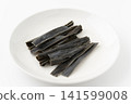 Chewing kelp on a plate against a white background. 141599008