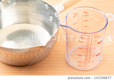 Measuring cup and Yukihira pot Measuring cup and Yukihira pot 141599877
