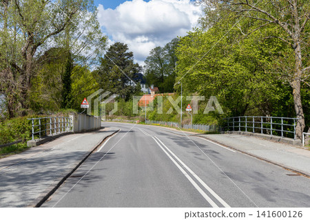 Eco friendly urban landscape with empty road and green park area. Eco friendly urban landscape with empty road and green park area. 141600126