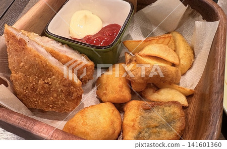 A platter of freshly fried chicken and french fries. A platter of freshly fried chicken and french fries. 141601360