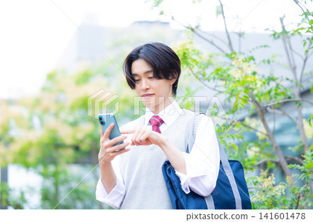 Student: A male student looking at his smartphone. Photo cooperation: Denpa Gakuen Tokyo Electronics College. Student: A male student looking at his smartphone. Photo cooperation: Denpa Gakuen Tokyo Electronics College. 141601478