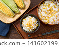Corn rice, a summer mixed rice dish served in a wooden rice container and a bowl. 141602199
