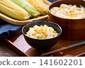 Corn rice, a summer mixed rice dish served in a wooden rice container and a bowl. 141602201