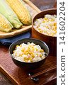 Corn rice, a summer mixed rice dish served in a wooden rice container and a bowl. 141602204