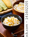 Corn rice, a summer mixed rice dish served in a wooden rice container and a bowl. 141602205