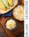 Corn rice, a summer mixed rice dish served in a wooden rice container and a bowl. 141602206