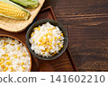 Corn rice, a summer mixed rice dish served in a wooden rice container and a bowl. 141602210