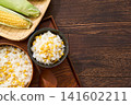 Corn rice, a summer mixed rice dish served in a wooden rice container and a bowl. 141602211