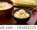 Corn rice, a summer mixed rice dish served in a wooden rice container and a bowl. 141602215